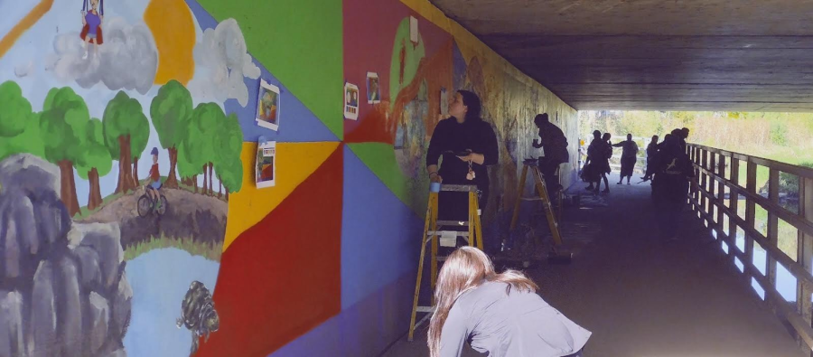 Art Club students fixing the mural.