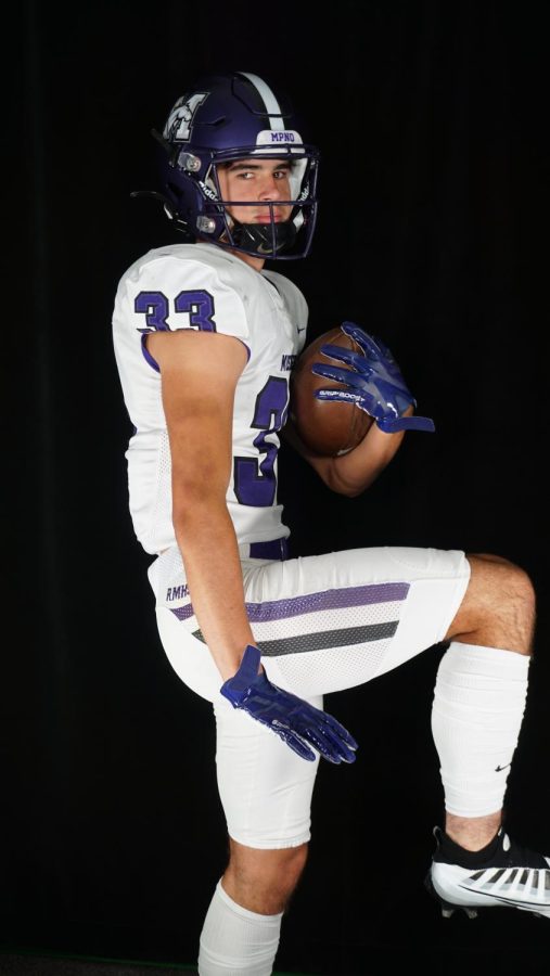 Senior Skip Rozanski poses as the "Heisman" trophy.