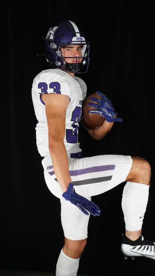 Senior Skip Rozanski poses as the Heisman trophy.